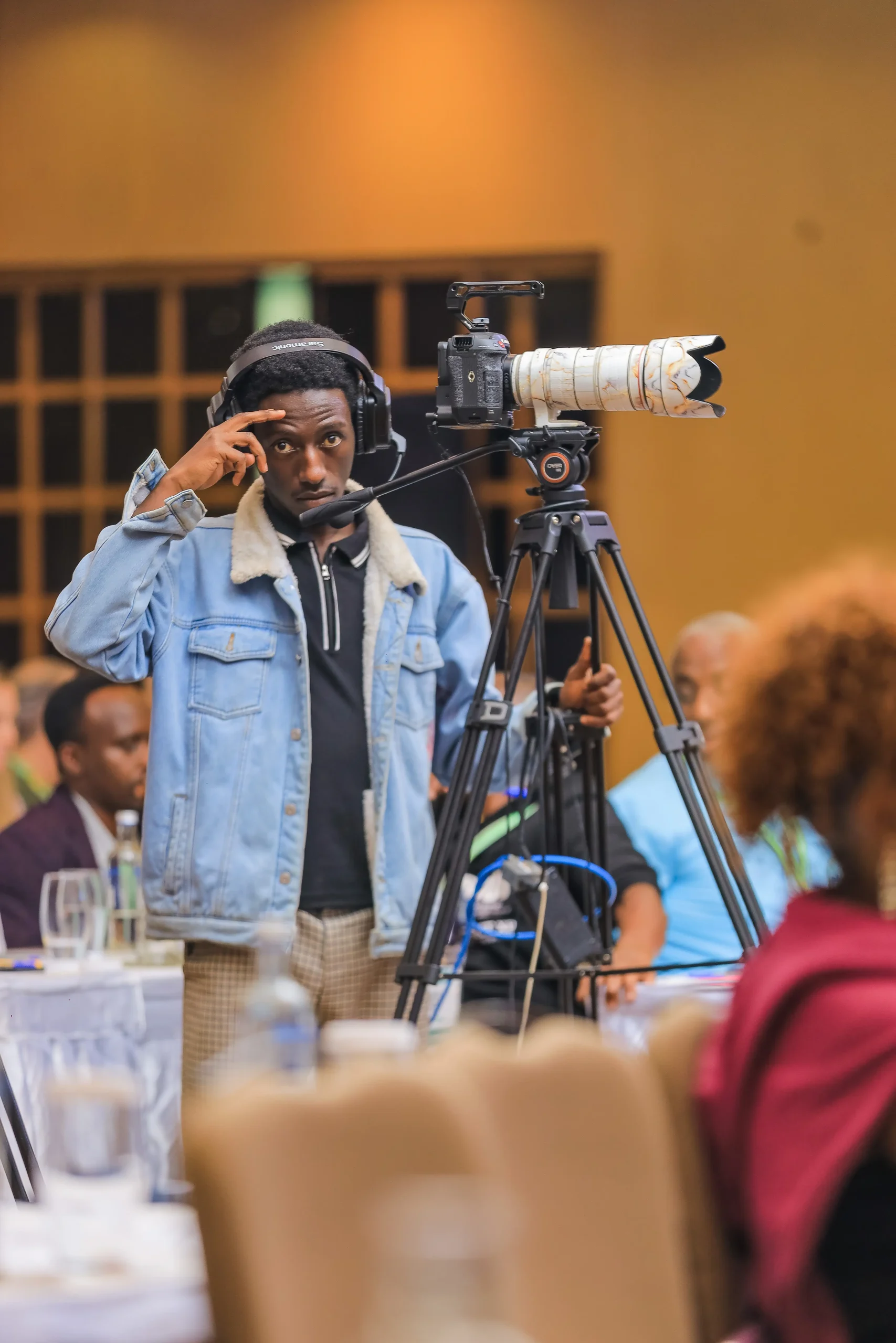 A camera operator filming at an event